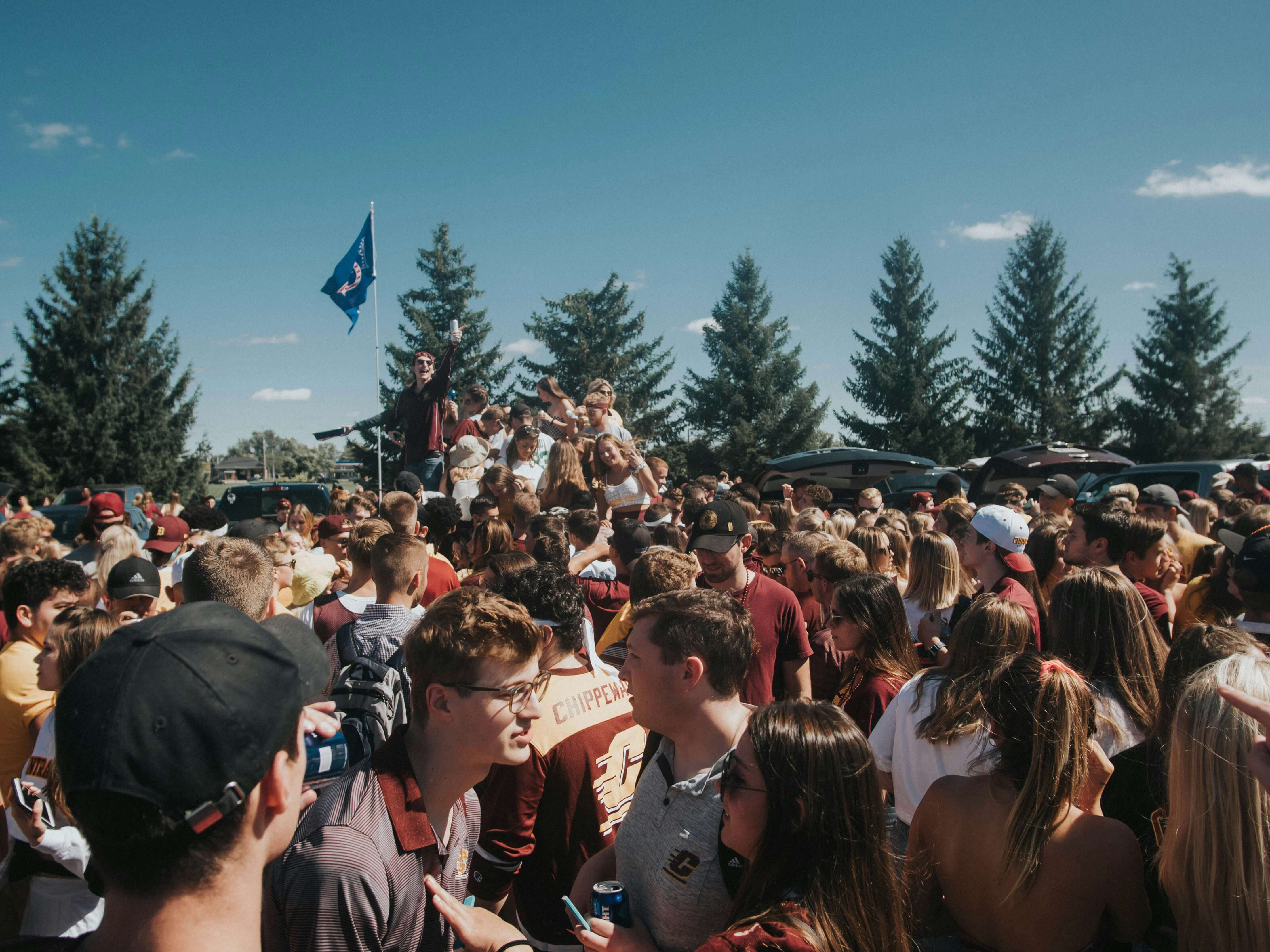 College football fans gathering outdoors for a game day tailgate
