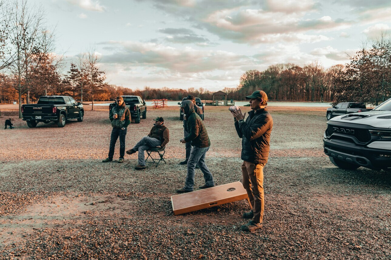 men playing cornhole